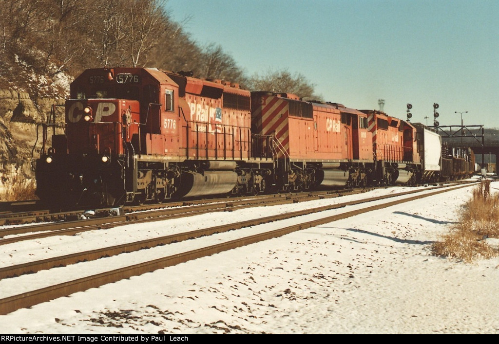 Three EMD's power an manifest west out of the yard